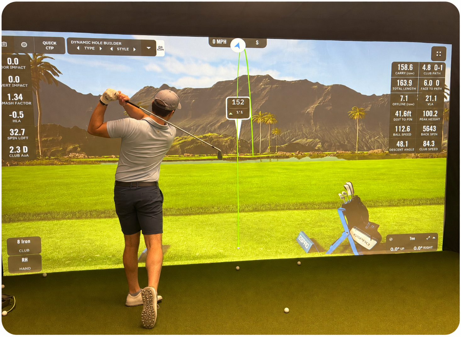 Golf coach reviewing radar launch monitor data on screen with a developing golfer during a lesson at ATX Golf Performance in Austin, Texas