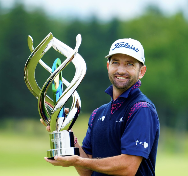 Professional golfer Jbe Kruger holding a tour trophy, coached by ATX Golf Performance's Martin du Toit.