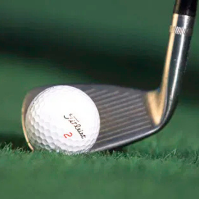 Golf chipping technique with toe down to reduce friction on grain