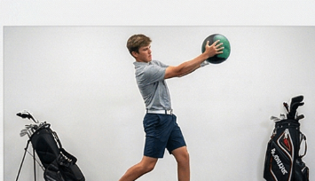 Junior golfer training rotational power with a medicine ball