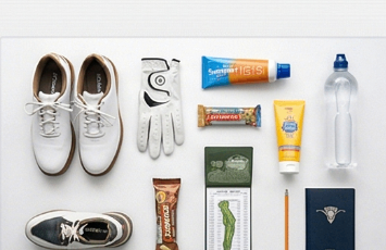 Golf tournament prep items including sunscreen, water bottle, shoes, and yardage book