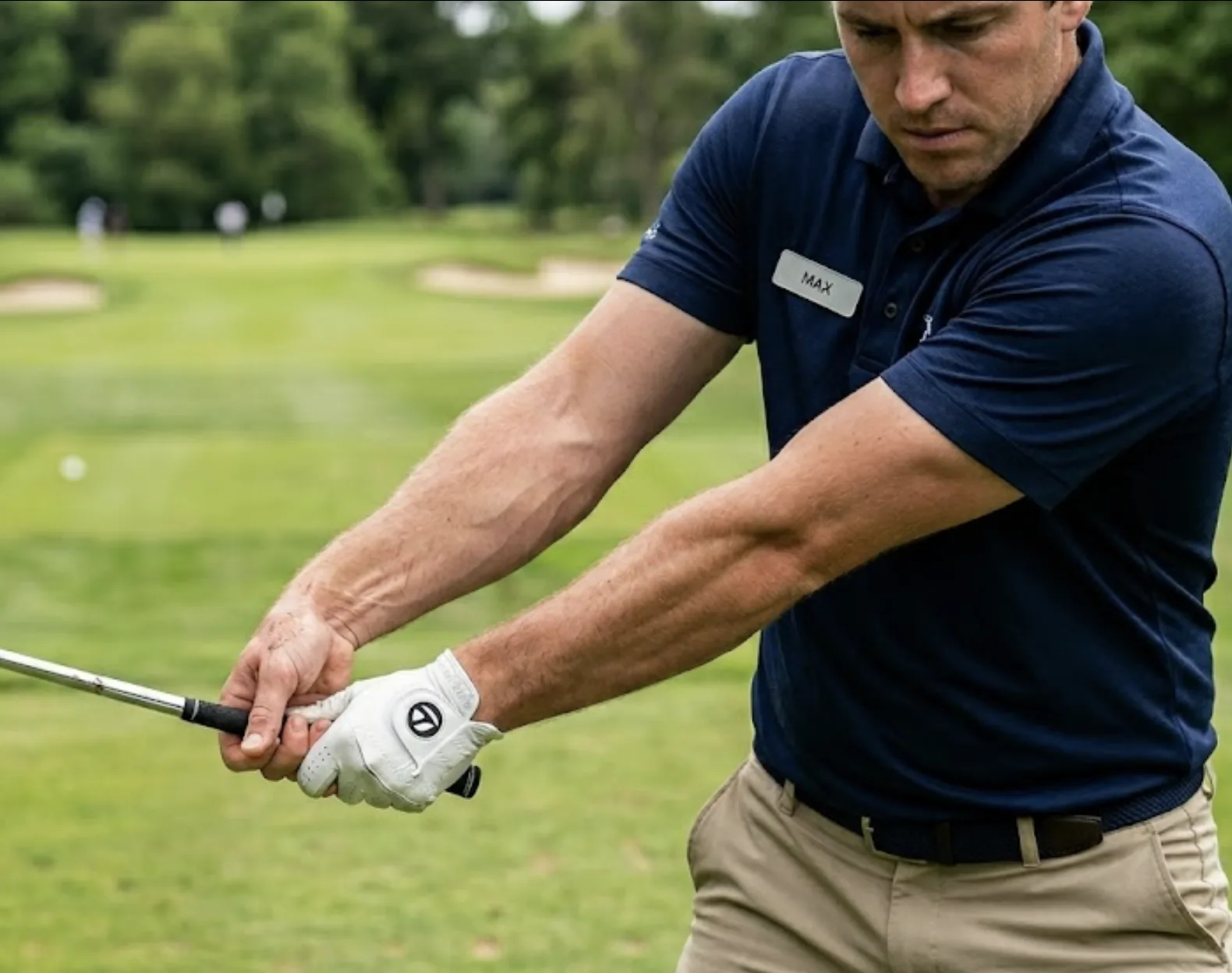 Golf coach demonstrating flat lead wrist and stable forearm position to fix flipping, casting, and chicken wing at impact