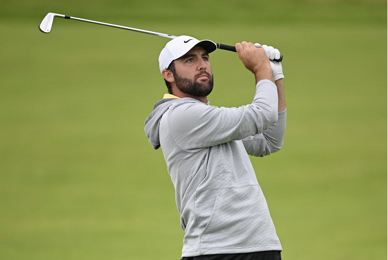 Scottie Scheffler holding his iron finish position eyes on ball flight, demonstrating feel over mechanics in the golf swing